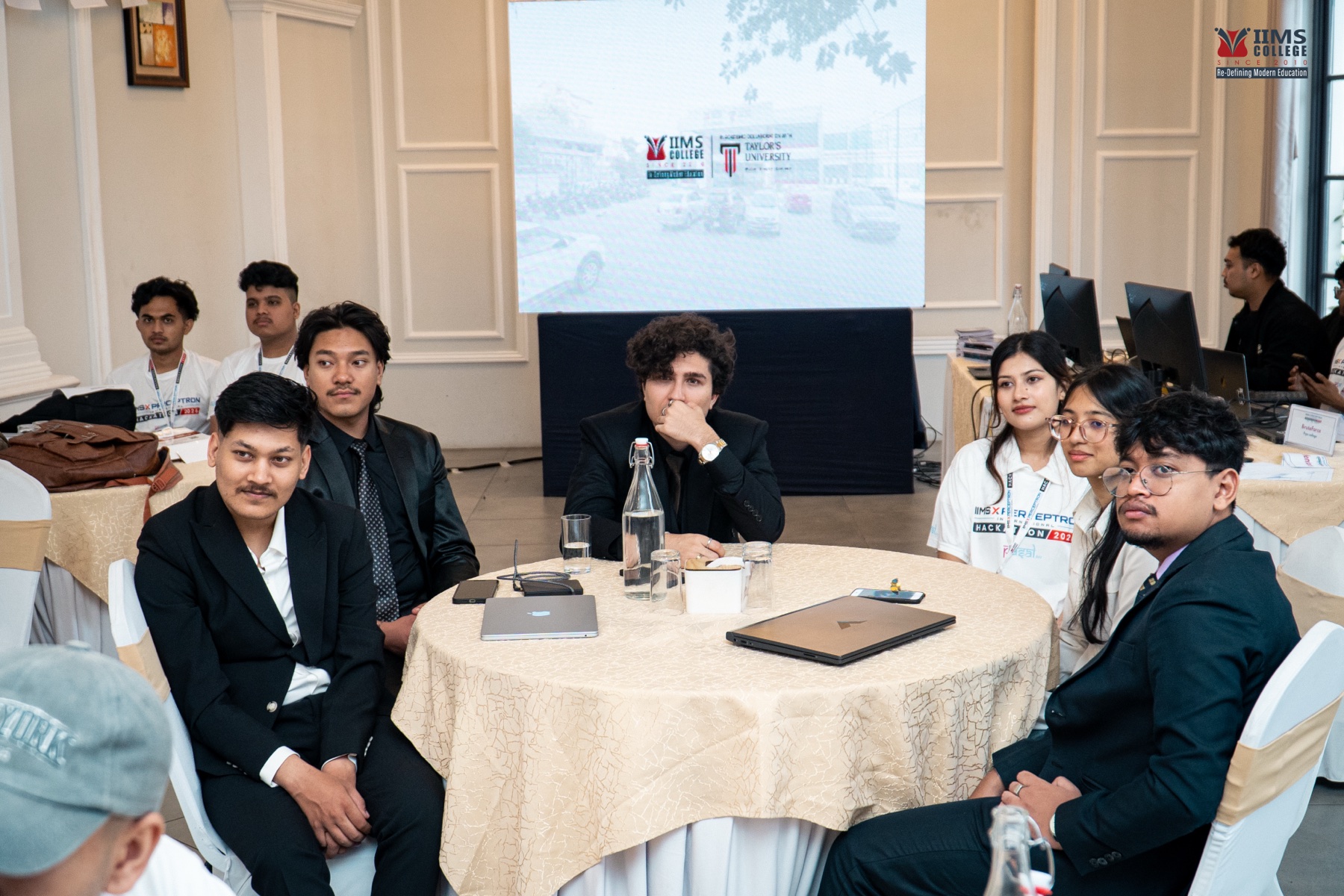 An international participant team gathered around a table during the hackathon